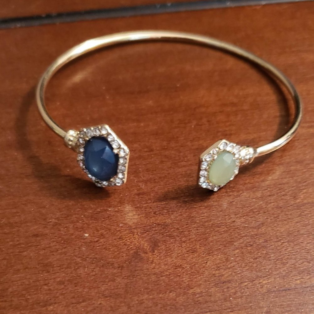 gold open bracelet with emerald and jade stones with diamond accents